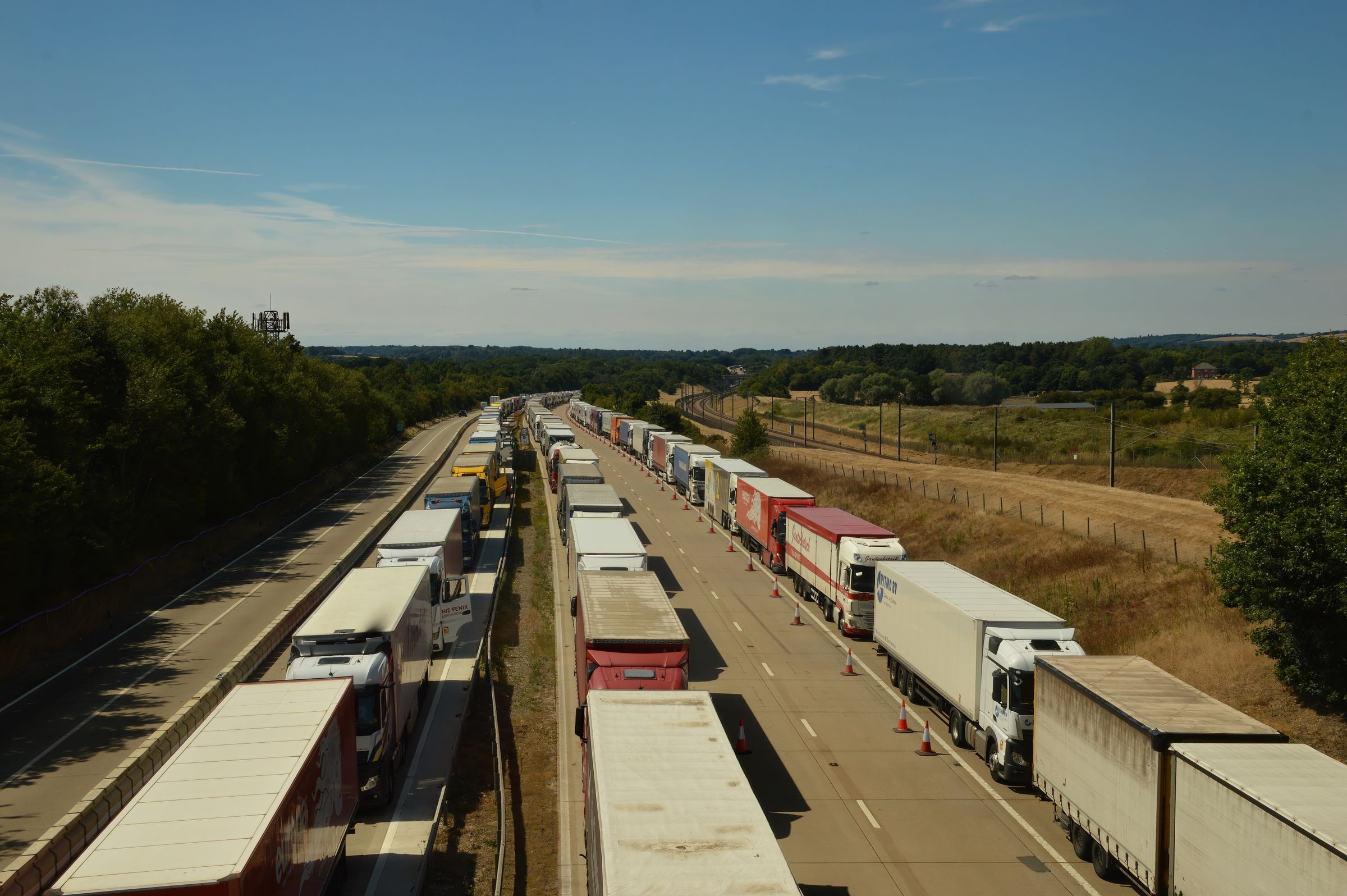 Freight trucks queued along a regional highway corridor