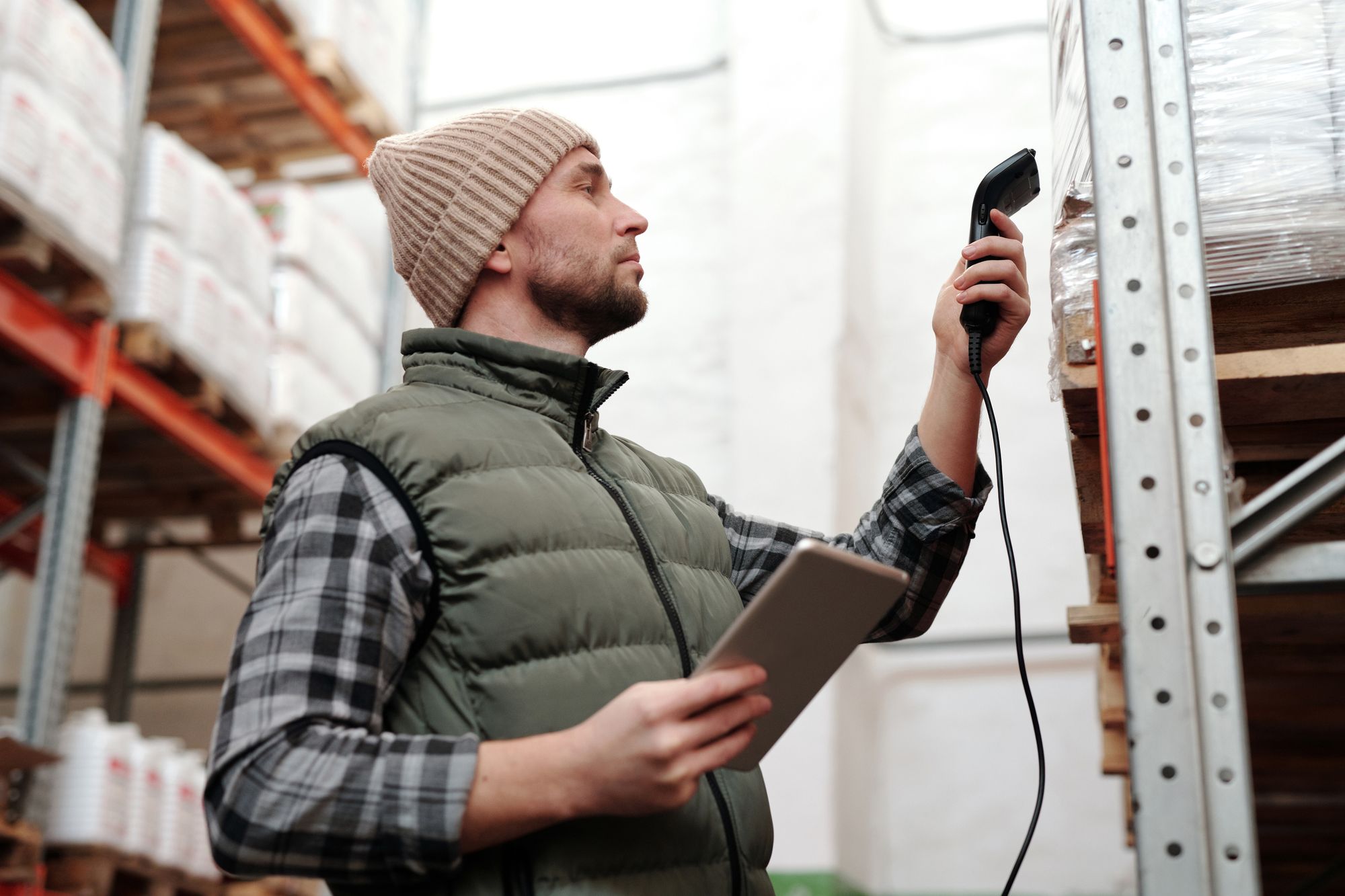 A warehouse operator scanning cargo with a handheld data device
